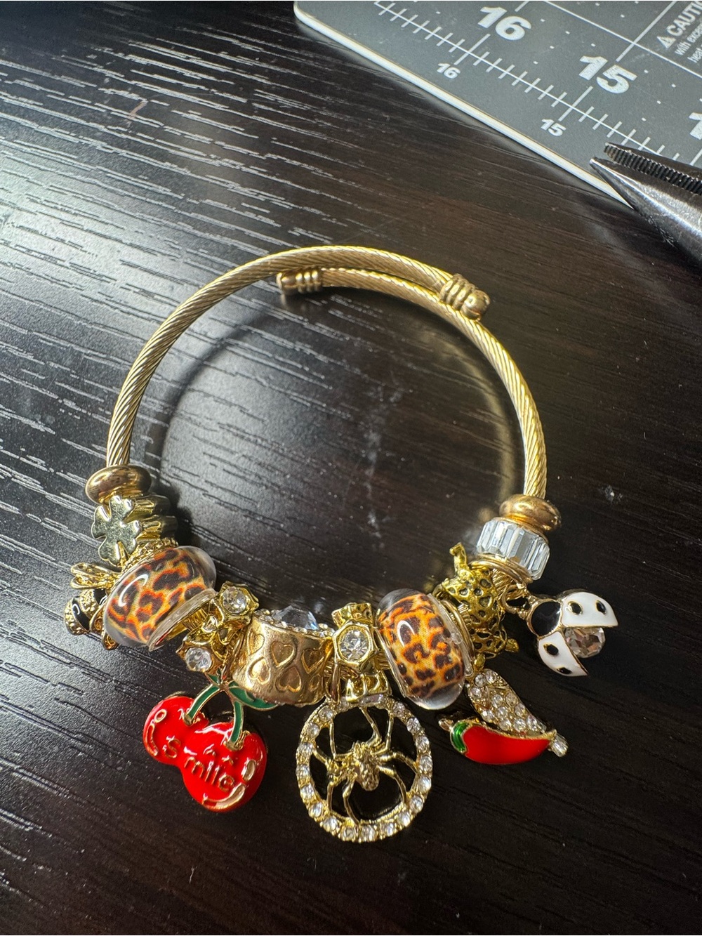 Gold-Tone Charm Bracelet with Leopard Beads and Red Enamel Charms